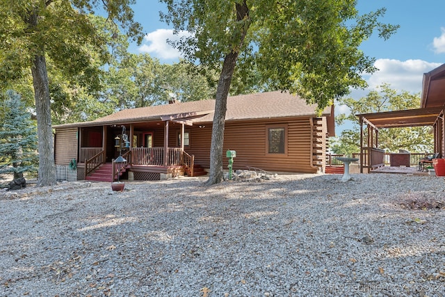 log home featuring a wooden deck