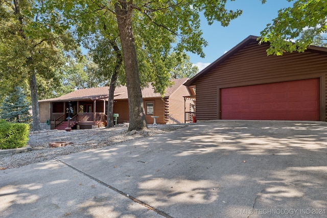 view of front of home with a garage and a porch