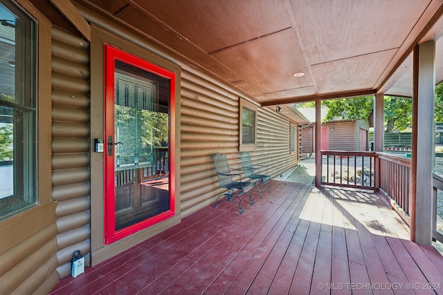 wooden terrace with a storage unit