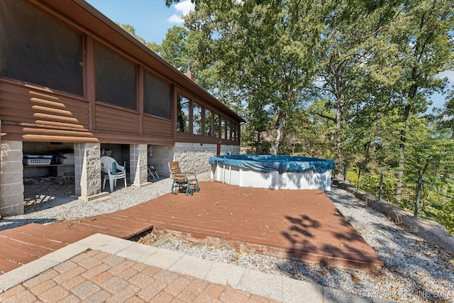 exterior space with a sunroom and a swimming pool side deck