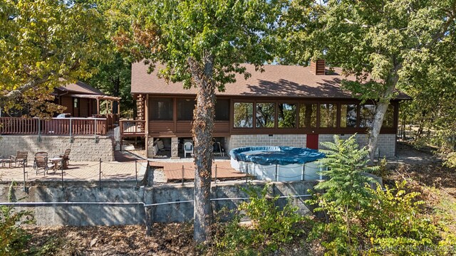 back of house with a patio area and a swimming pool side deck