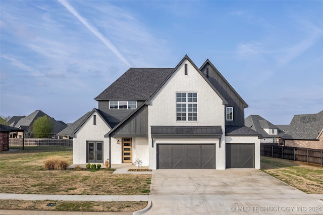 view of front of property with a garage and a front lawn