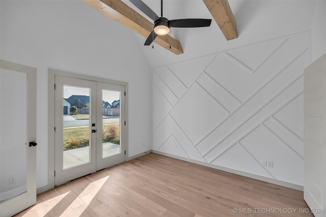 unfurnished room with beamed ceiling, ceiling fan, french doors, and light hardwood / wood-style flooring