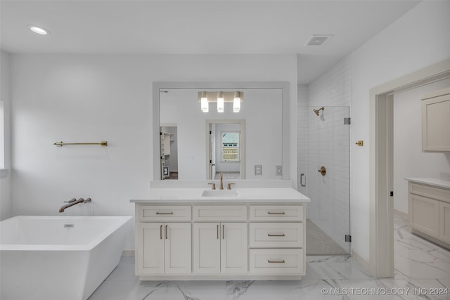 bathroom with independent shower and bath and vanity