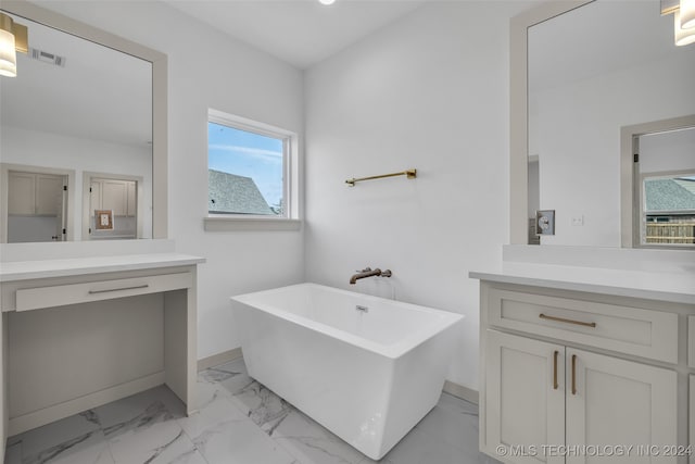 bathroom with vanity and a washtub