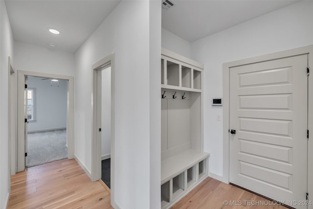 mudroom with wood-type flooring and ceiling fan