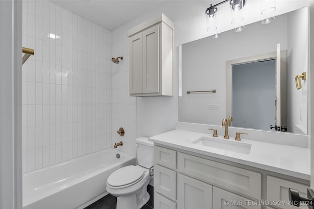 full bathroom with tiled shower / bath combo, vanity, and toilet