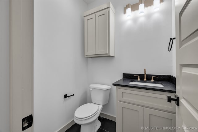 bathroom with vanity, toilet, and tile patterned floors