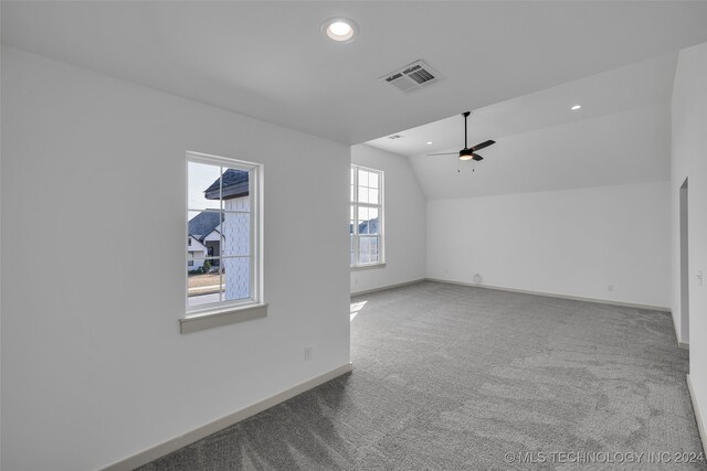 carpeted empty room with lofted ceiling and ceiling fan