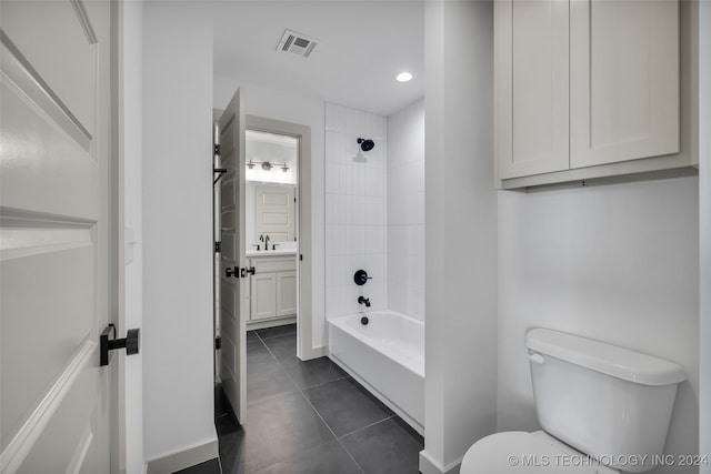 full bathroom with vanity, tiled shower / bath combo, toilet, and tile patterned floors