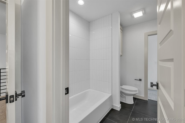 bathroom featuring tiled shower / bath combo, toilet, and tile patterned floors