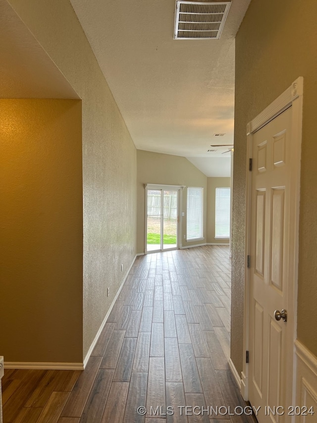 corridor with dark hardwood / wood-style flooring