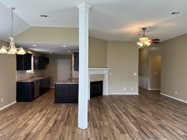 kitchen with backsplash, ceiling fan, dark hardwood / wood-style floors, and a fireplace