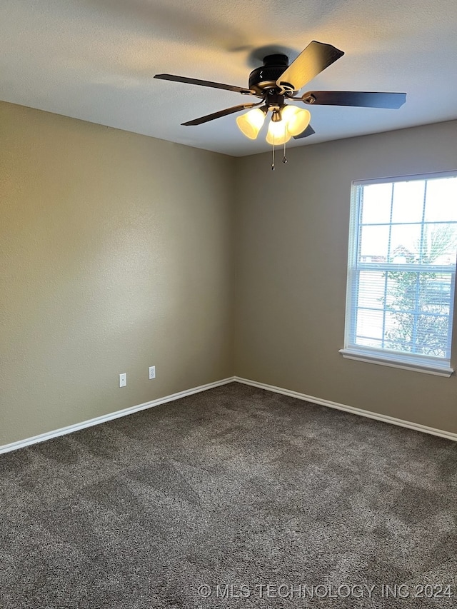 carpeted spare room with ceiling fan and a textured ceiling