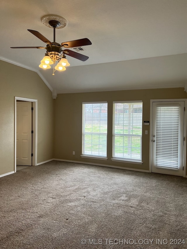 carpeted empty room featuring ornamental molding, lofted ceiling, and ceiling fan