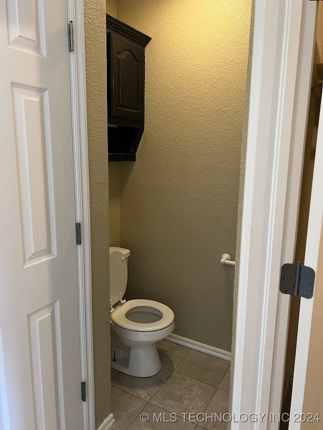 bathroom featuring toilet and tile patterned floors