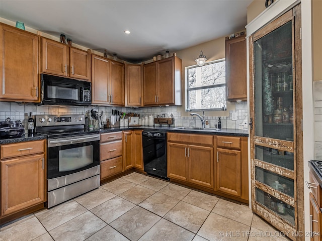 kitchen with black appliances, backsplash, sink, and light tile patterned floors