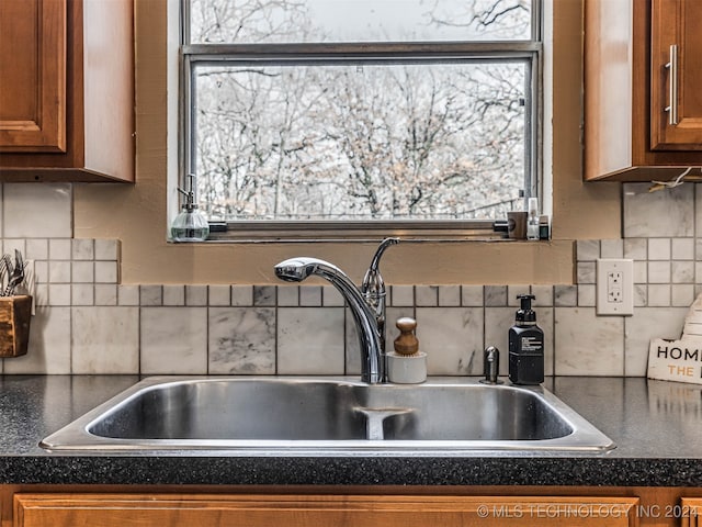 kitchen featuring backsplash and sink