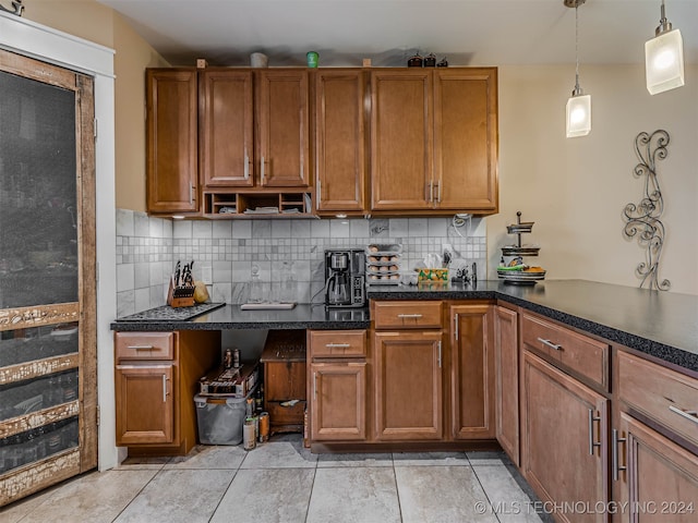 kitchen with decorative backsplash, light tile patterned floors, and pendant lighting