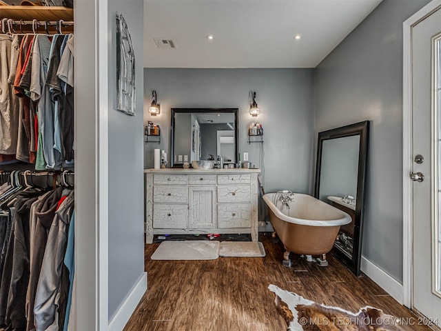 bathroom featuring a bathtub, vanity, and hardwood / wood-style floors