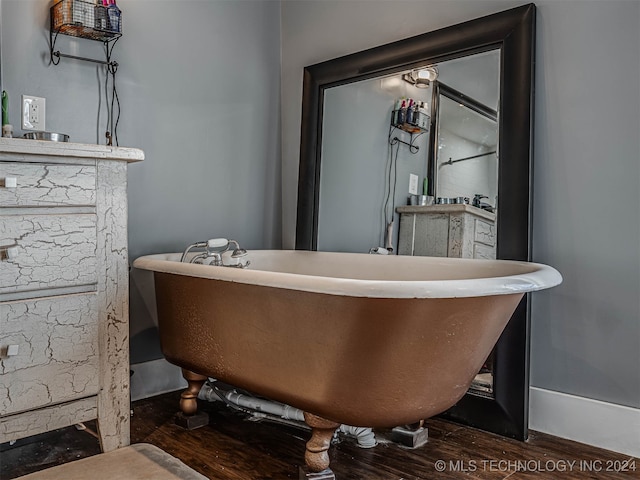 bathroom with hardwood / wood-style flooring and a bathtub