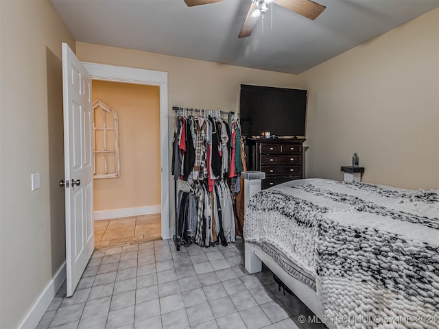 tiled bedroom featuring ceiling fan