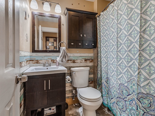 bathroom with tile walls, vanity, and toilet