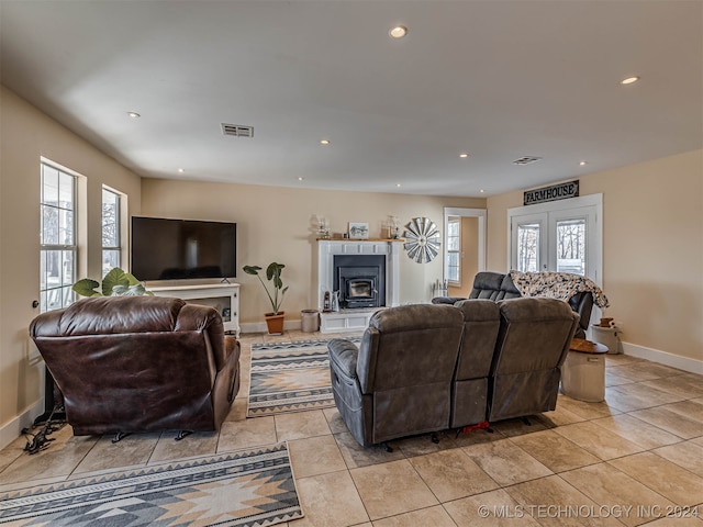 living room with french doors, light tile patterned flooring, and plenty of natural light