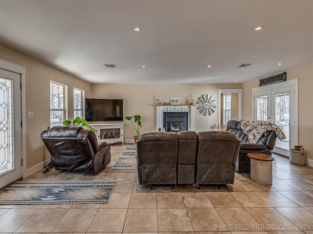 living room featuring light tile patterned flooring and french doors