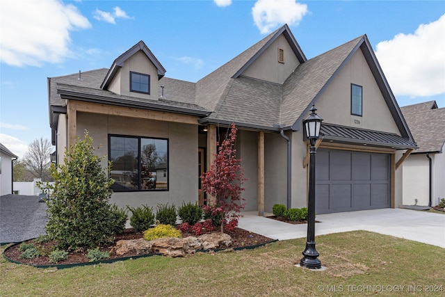 view of front facade featuring a garage and a front lawn