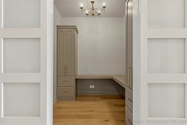 interior space featuring an inviting chandelier and light hardwood / wood-style flooring