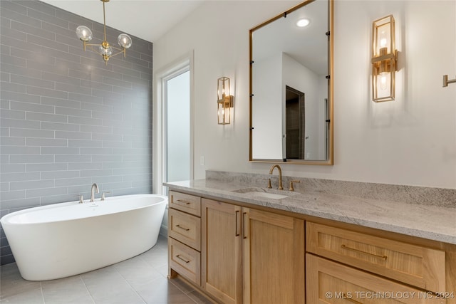 bathroom featuring tile walls, tile patterned flooring, vanity, and a bathtub