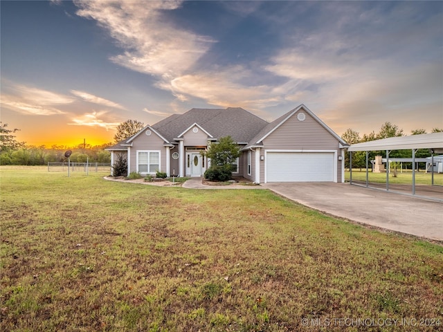 view of front of house featuring a yard and a garage