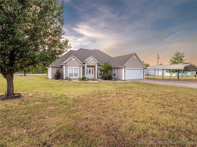 view of front of home with a lawn, a carport, and a garage