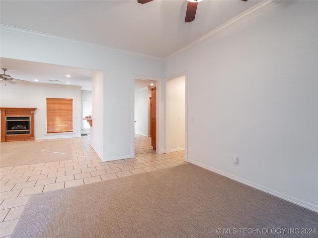 tiled empty room with ceiling fan and ornamental molding