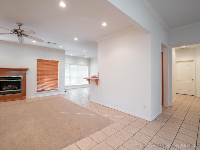 unfurnished living room featuring ceiling fan, crown molding, and light tile patterned floors