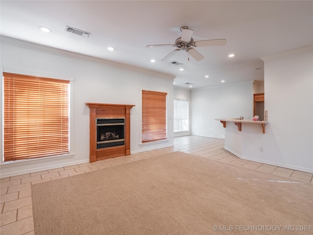 unfurnished living room featuring ceiling fan, light colored carpet, and crown molding