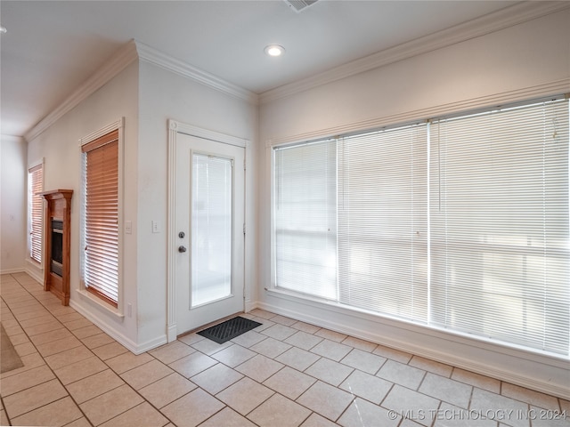 doorway to outside featuring crown molding and light tile patterned floors