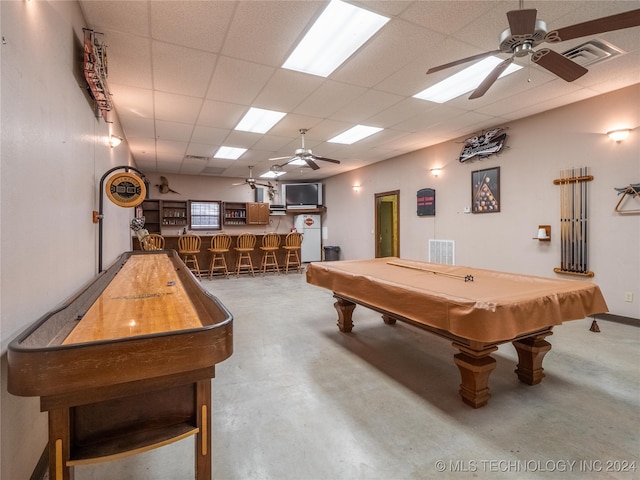 recreation room featuring ceiling fan, indoor bar, concrete flooring, pool table, and a paneled ceiling