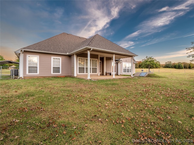 rear view of property with a patio area and a yard