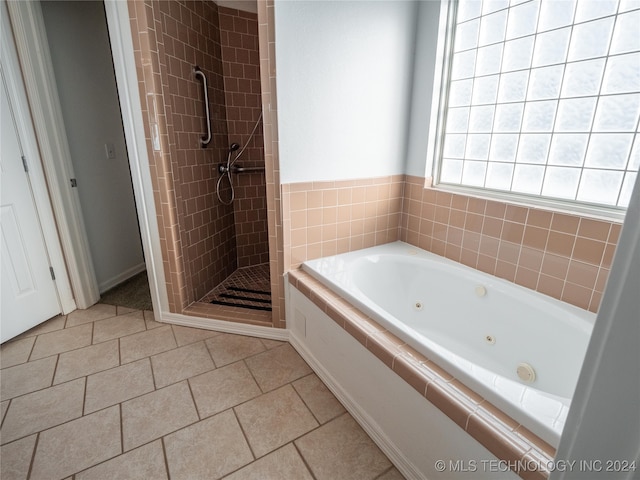 bathroom with tile patterned flooring and independent shower and bath