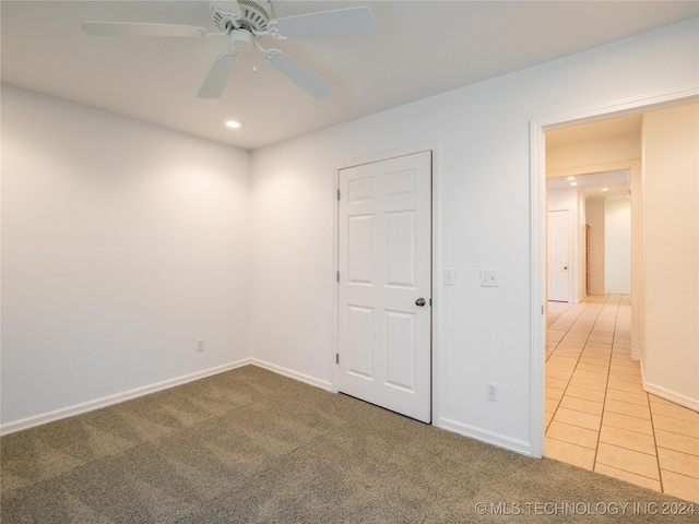 unfurnished bedroom with ceiling fan and carpet