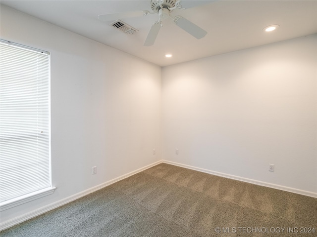 unfurnished room with ceiling fan and carpet floors