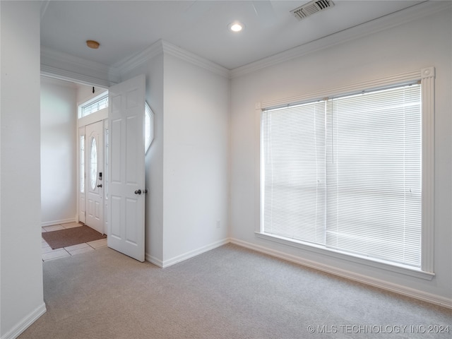 carpeted empty room featuring crown molding