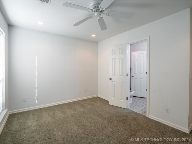 unfurnished bedroom featuring carpet, ensuite bath, and ceiling fan