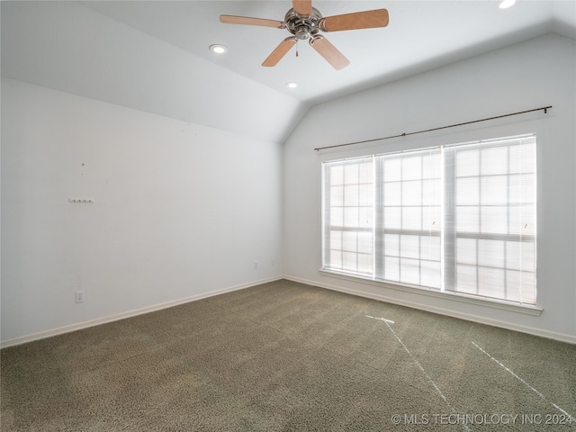 carpeted empty room with lofted ceiling and ceiling fan