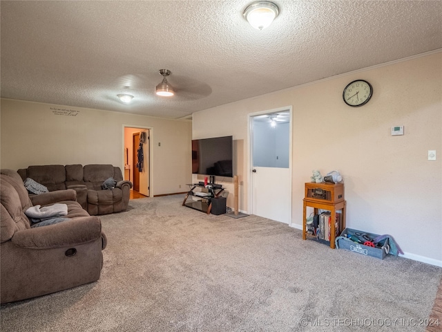 carpeted living room with ceiling fan and a textured ceiling