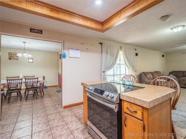 kitchen featuring a textured ceiling, a center island, stainless steel electric stove, and light tile patterned flooring