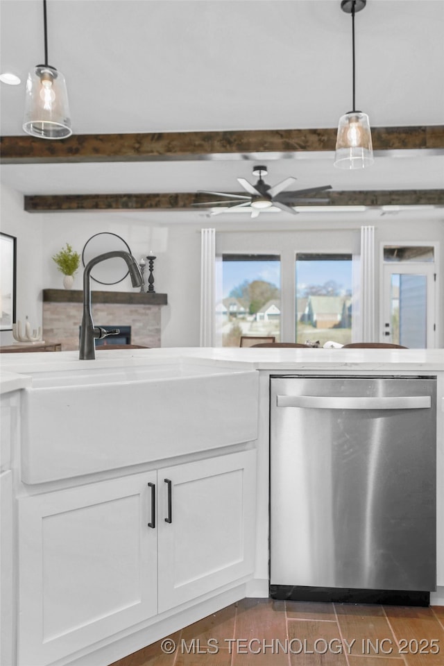 kitchen with ceiling fan, decorative light fixtures, stainless steel dishwasher, and white cabinets