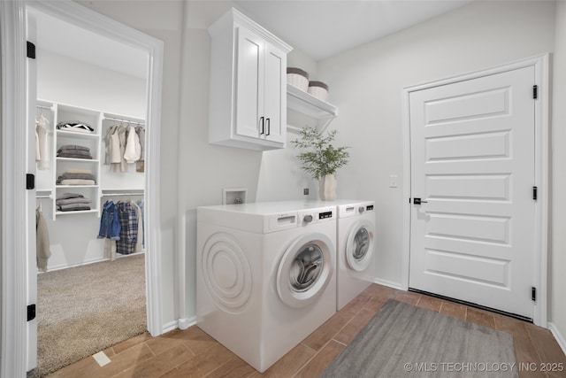 laundry area with cabinets, light colored carpet, and washer and clothes dryer